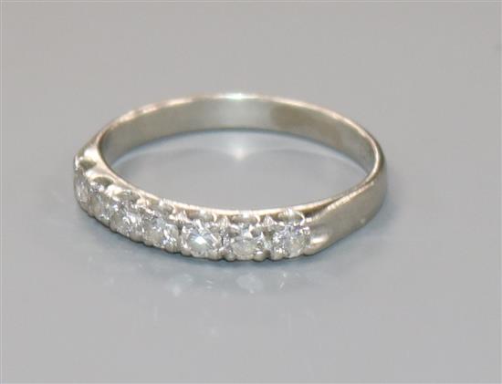 A white metal and seven stone diamond half eternity ring, size P.